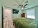 Comfortable bedroom with ceiling fan, TV, and view of the window at 3324 Port Charlotte Blvd, Port Charlotte, FL 33952