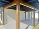 A cozy outdoor carport featuring natural wood pillars and lighting, ideal for relaxation and entertaining guests at 3324 Port Charlotte Blvd, Port Charlotte, FL 33952