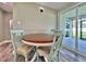 Charming dining area with a round table, vintage chairs, and views of the outdoor patio at 3324 Port Charlotte Blvd, Port Charlotte, FL 33952
