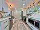 Beautifully updated kitchen with stainless steel appliances and white cabinets, offering plenty of counter space at 3324 Port Charlotte Blvd, Port Charlotte, FL 33952