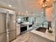 Modern kitchen featuring stainless steel appliances, white cabinetry, quartz countertops, and stylish pendant lighting at 3324 Port Charlotte Blvd, Port Charlotte, FL 33952