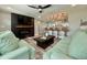 Open concept living room with bar seating, a modern fireplace, and stylish, neutral decor for seamless entertaining at 3324 Port Charlotte Blvd, Port Charlotte, FL 33952