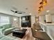 Inviting living room with modern fireplace, TV, comfortable seating, and stylish bar with seating at 3324 Port Charlotte Blvd, Port Charlotte, FL 33952