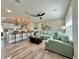 Open concept living room featuring bar seating, modern ceiling fan, and stylish, neutral decor for seamless entertaining at 3324 Port Charlotte Blvd, Port Charlotte, FL 33952