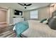 Serene bedroom with a ceiling fan, an ample dresser, and comfortable bedding with natural light at 3324 Port Charlotte Blvd, Port Charlotte, FL 33952