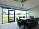 Enclosed patio with outdoor seating and a ceiling fan at 3324 Port Charlotte Blvd, Port Charlotte, FL 33952