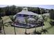 Aerial view of a home showcasing a fenced in backyard with a screened-in pool and tall palm trees at 384 Viedma St, Punta Gorda, FL 33983