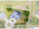 Aerial view of a property showcasing the home, pool, and a surrounding lush green lot outlined in white at 384 Viedma St, Punta Gorda, FL 33983
