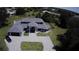 Aerial view of a property featuring a well-manicured lawn, a gray brick driveway, and a two-car garage at 384 Viedma St, Punta Gorda, FL 33983