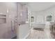 Bright bathroom features a modern glass shower, soaking tub, and wood-look tile floor at 384 Viedma St, Punta Gorda, FL 33983