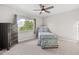 Bright bedroom with a large window, a ceiling fan, and a vintage blue painted chest at 384 Viedma St, Punta Gorda, FL 33983