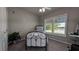 Cozy bedroom with a metal frame bed, ceiling fan, and window with plantation shutters at 384 Viedma St, Punta Gorda, FL 33983