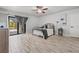 Well-lit bedroom with wood-look tile flooring and access to the outdoor screened-in patio at 384 Viedma St, Punta Gorda, FL 33983