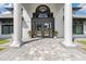 Grand entrance with stone walkway leading up to the white pillared entry and black doors at 384 Viedma St, Punta Gorda, FL 33983