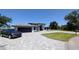 Spacious home with an interlock driveway, 3 car garage, and a lush front lawn at 384 Viedma St, Punta Gorda, FL 33983