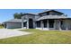 Elegant two-story home with a stately entrance, manicured lawn, and a gray brick driveway at 384 Viedma St, Punta Gorda, FL 33983