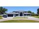 Stunning contemporary home with a grand entrance, circular driveway, and manicured lawn at 384 Viedma St, Punta Gorda, FL 33983
