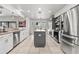 Bright kitchen with stainless appliances, granite counters, island, and light tile flooring at 384 Viedma St, Punta Gorda, FL 33983