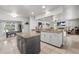 Open kitchen with granite counters, central island, stainless sink, and views of the living area at 384 Viedma St, Punta Gorda, FL 33983