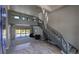Open-concept living room with staircase, contemporary lighting, and view to the backyard pool at 384 Viedma St, Punta Gorda, FL 33983