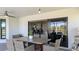 Outdoor patio featuring a dining table and grill area, connecting to the interior via sliding glass doors at 384 Viedma St, Punta Gorda, FL 33983