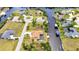 Top-down perspective of a canal-front home with a swimming pool and a private dock in a community at 4473 Sweetbay St, Port Charlotte, FL 33948