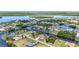 Wide angle aerial showcases a neighborhood with canal-front houses, lush landscaping, and a tranquil setting at 4473 Sweetbay St, Port Charlotte, FL 33948