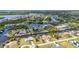 Scenic aerial view of a waterfront neighborhood showcasing homes with canals, boat docks, and lush landscaping at 4473 Sweetbay St, Port Charlotte, FL 33948
