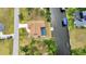 Aerial view of waterfront property with a private pool and dock overlooking the canal at 4473 Sweetbay St, Port Charlotte, FL 33948