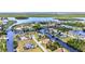 Expansive aerial view capturing a beautiful waterfront community with lush greenery and canal access at 4473 Sweetbay St, Port Charlotte, FL 33948