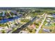 Overhead shot of a lovely waterside community displaying canal-front homes and verdant landscaping at 4473 Sweetbay St, Port Charlotte, FL 33948