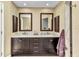 Bathroom featuring double sinks, marble countertops, and framed mirrors at 4473 Sweetbay St, Port Charlotte, FL 33948