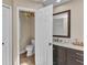 Half bathroom featuring marble countertops, toilet, mirror, and ceiling fan at 4473 Sweetbay St, Port Charlotte, FL 33948