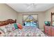 Comfortable bedroom with tropical-themed bedding and view of the private pool at 4473 Sweetbay St, Port Charlotte, FL 33948
