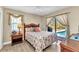 Bedroom featuring a ceiling fan, light wood floors, and access to the pool at 4473 Sweetbay St, Port Charlotte, FL 33948