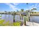 Private boat lift on a wooden dock with beautiful view of the canal at 4473 Sweetbay St, Port Charlotte, FL 33948