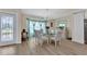 Elegant dining room boasting natural light, modern chandelier, and views of the front entrance at 4473 Sweetbay St, Port Charlotte, FL 33948