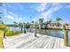 Private wooden dock on the canal featuring boat lift and sunny views of the neighborhood at 4473 Sweetbay St, Port Charlotte, FL 33948