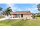 Charming single-story home with a well-manicured lawn, mature landscaping, and an inviting front entrance at 4473 Sweetbay St, Port Charlotte, FL 33948