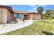 Charming front entrance with well-maintained landscaping and a paved walkway, creating a welcoming approach at 4473 Sweetbay St, Port Charlotte, FL 33948