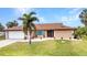 Inviting home with a fresh, well-maintained exterior, complemented by a beautiful lawn and decorative plantings at 4473 Sweetbay St, Port Charlotte, FL 33948