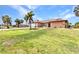 Charming single-story home with lush green lawn, palm trees, and a spacious driveway at 4473 Sweetbay St, Port Charlotte, FL 33948