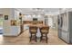 Spacious kitchen with island seating, stainless appliances, and wood floors at 4473 Sweetbay St, Port Charlotte, FL 33948