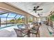 Spacious screened lanai with dining area, outdoor seating, and pool access at 4473 Sweetbay St, Port Charlotte, FL 33948