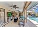 Spacious lanai offers a relaxing atmosphere with comfortable furniture, a TV, and a view of the pool at 4473 Sweetbay St, Port Charlotte, FL 33948