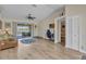 Open-concept living room featuring light wood floors, a vaulted ceiling, and a view of the outdoor pool at 4473 Sweetbay St, Port Charlotte, FL 33948