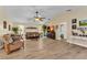 Spacious living room with wood flooring, ceiling fan, and plenty of natural light at 4473 Sweetbay St, Port Charlotte, FL 33948