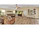 Bright living room with wood floors, neutral paint, ceiling fan, and lots of windows at 4473 Sweetbay St, Port Charlotte, FL 33948