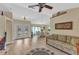 Spacious open-concept living area showcasing wood floors, bright lighting, and an adjacent dining space at 4473 Sweetbay St, Port Charlotte, FL 33948