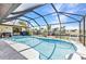 Stunning pool area surrounded by a screened enclosure and lush landscaping, perfect for outdoor entertaining at 4473 Sweetbay St, Port Charlotte, FL 33948